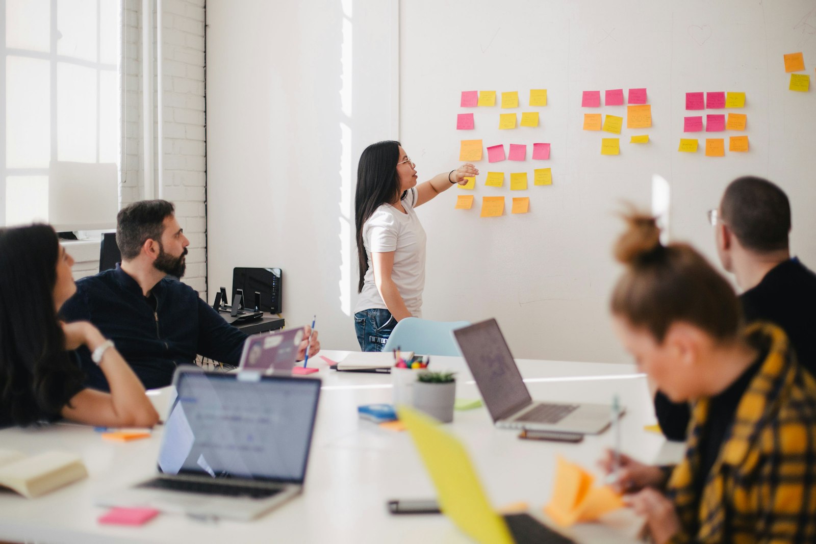 Team brainstorming with sticky notes on a wall